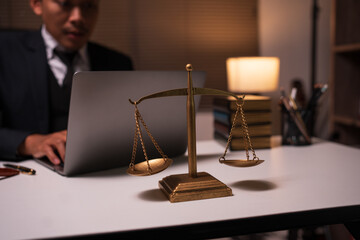 A lawyer is reading a book about law in the office.
