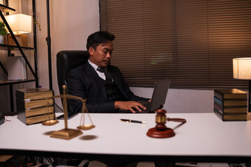 Male lawyer working on legal matters in a law office	