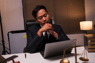 Male lawyer working on legal matters in a law office	