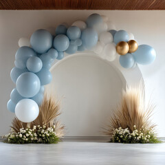 Soft blue and white balloon arch with gold accents, pampas grass, and white flowers creates elegant, festive event backdrop indoors