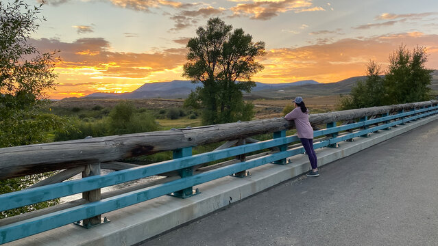 Woman Looking at Sunset over the Mountains in Granby Colorado
