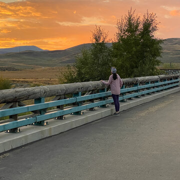 Woman Looking at Sunset over the Mountains in Granby Colorado
