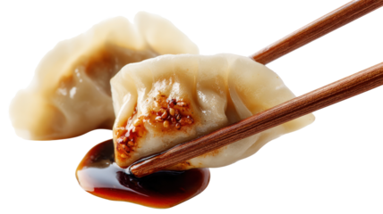Delicious dumpling held with chopsticks, dripping soy sauce, isolated on a white background