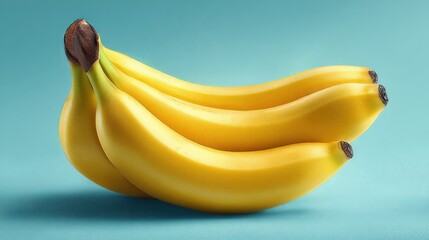 Fresh ripe yellow bananas bunch isolated on light teal background 