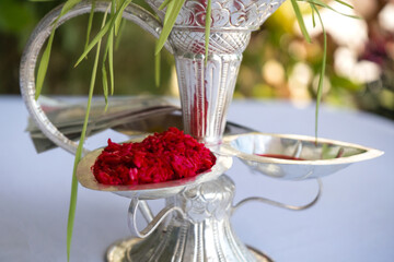 Tika and Jamara placed in a silver utensil with barley sprouts, money, and fruits for the Vijaya Dashami ceremony during Dashain festival in Nepal.