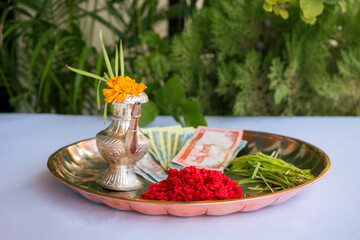 Tika and Jamara placed in a silver utensil with barley sprouts, money, and fruits for the Vijaya Dashami ceremony during Dashain festival in Nepal.