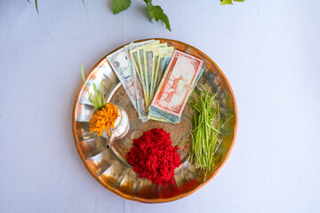 Tika and Jamara placed in a silver utensil with barley sprouts, money, and fruits for the Vijaya Dashami ceremony during Dashain festival in Nepal.