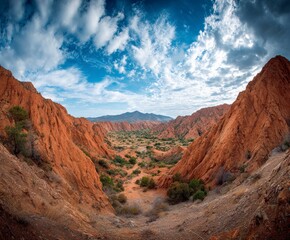 Vibrant desert canyon landscape with dramatic rock formations and vast blue sky