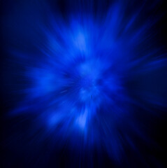 Blue explosive burst of light on a dark background. Fast motion explosion on a slow shutter speed. Great abstract blue background