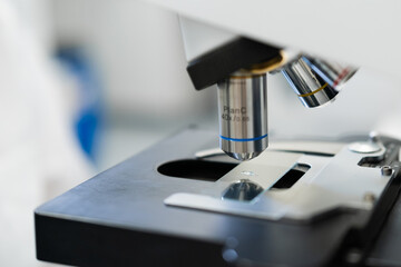 Close up view of microscope objective lenses focusing on a sample.