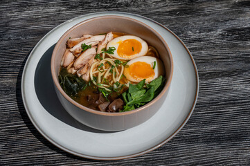 Ramen soup in cafe on wooden table. 