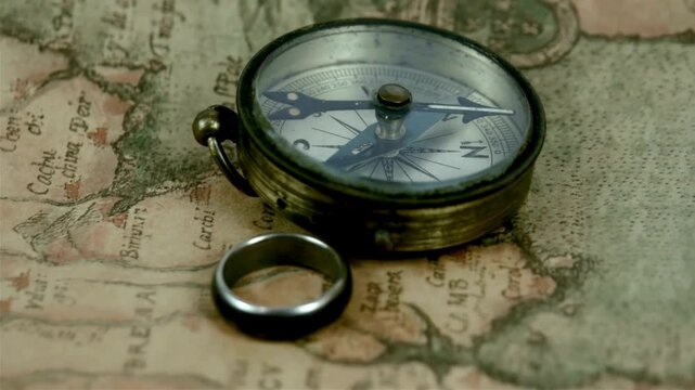 Magnetic compass on world map.Travel, geography, navigation, tourism and exploration concept background. antique compass on ancient map. Old vintage retro compass on ancient map background.
