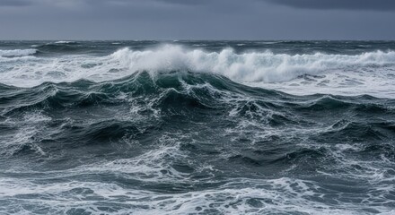 Fototapeta premium Crashing waves under an overcast sky, turbulent ocean seascape view