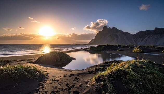 Brilliant golden sunset casts warm, radiant light across a tranquil black sand beach, where a still water pool mirrors the sky and majestic, rugged mountains rise in the distance, creating a stunning. - Powered by Adobe