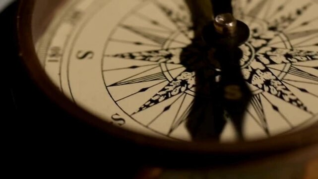 closeup of old style gold compass. Retro styled golden compass and old white nautical chart close-up. Vintage still life. Sailing accessories. Travel, navigation, history, collecting, hobby.