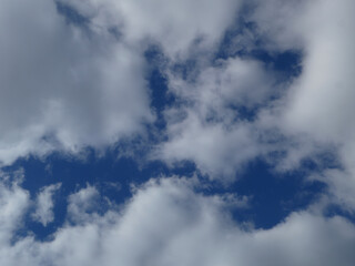 Bright Blue Sky Peeking Through White Clouds