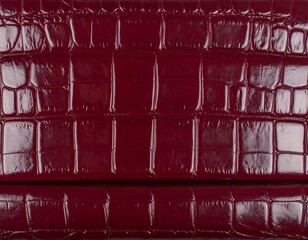 Close-up view of deep burgundy crocodile embossed leather