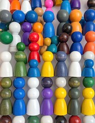 Colorful, wooden peg dolls arranged in a tidy, dense grid