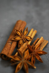 Close-up of Star Anise and Cinnamon Sticks on Dark Slate Background for Culinary Concepts