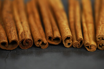 Close-Up of Cinnamon Sticks on Dark Surface - Aromatic Culinary Spice and Natural Home Remedy