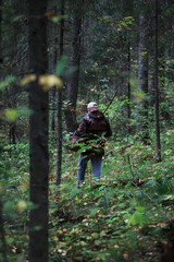 Naklejka premium Hunter in Dense Forest with Rifle and Backpack Exploring Adventure
