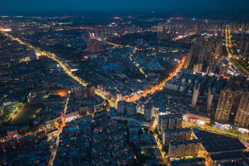 Suizhou City Hubei Province China urban landscape glows at night with illuminated streets and buildings showing city lights spreading.