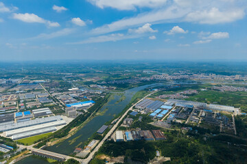 Suizhou City, Hubei Province, China spreads out under a blue sky with white clouds, showing buildings and a river.