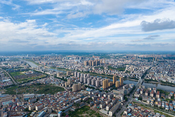 Suizhou City, Hubei Province, China expands with many buildings and a river under a cloudy sky.