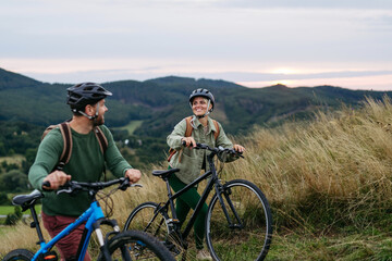 Fototapeta premium Couple cycling together in nature, smiling and enjoying outdoor adventure.