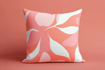 A decorative throw pillow features a vibrant pattern of abstract organic shapes in coral, pink, and white tones.