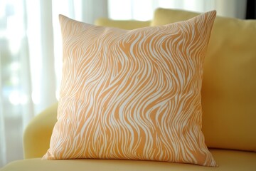 A close-up view of a decorative pillow, featuring a sophisticated, flowing, light-orange zebra-like pattern, resting comfortably on a bright yellow couch.
