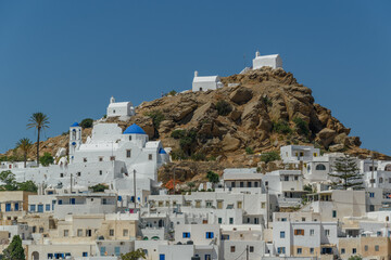 Fototapeta premium Ios Chora with Hilltop Churches under Clear Sky, Cyclades, Greece