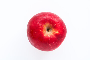Top view of a single, perfectly ripe red apple, showcasing its smooth skin and vibrant color, isolated on a clean white background.