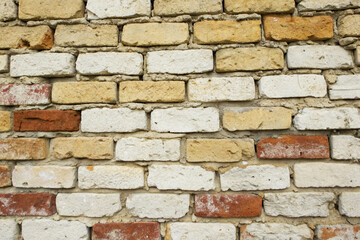 Old Rustic Brick Wall Texture with Mixed Colors of White, Yellow, and Red