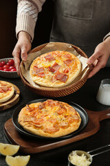 Woman Serving Homemade Cheesy Pizza with Pepperoni in Wicker Basket - Fresh Italian Food