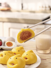 Adorable Yellow Dim Sum Buns with Sweet Filling and Cartoon Faces Served with Chopsticks