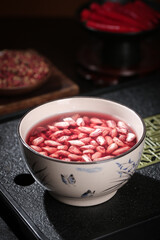 Red Peanuts Soaking in Water in Ceramic Bowl - Traditional Food Preparation of Fresh Groundnut Kernels