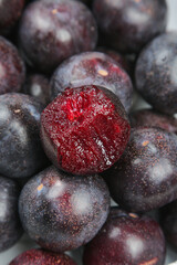 Fresh Red Flesh Plums Cut in Half Showing Vibrant Crimson Interior - Premium Stone Fruit