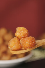 Dried Longan Fruit Kernels from Yunnan China on Wooden Spoon - Traditional Asian Sweet Snack