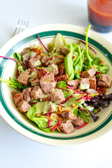 Visually striking steak salad with crisp greens, shredded beets, and creamy herb dressing—artfully styled for clean-eating campaigns, recipe sites, and premium health content.