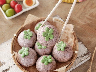 Purple Steamed Buns with Green Shamrock Decorations - Asian Dim Sum Dessert for St. Patrick's Day Celebration