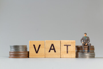 Miniature Business Concept with VAT and Coins