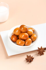 Baked Quail Eggs with Soy Sauce in White Bowl - Traditional Asian Dish with Star Anise