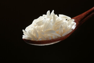 Long Grain White Rice in Wooden Spoon on Black Background - Premium Quality Fragrant Rice