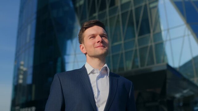 Handsome young businessman in elegant suit walking confidently downtown