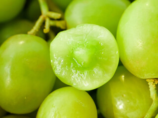 Fresh Green Grapes Close-up with Cut Half Showing Juicy Interior