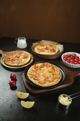 Fresh Baked Bacon Pizza with Cheese and Tomatoes on Rustic Wooden Serving Boards