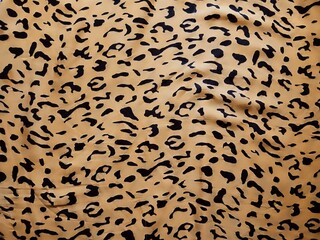 The pattern and background of the yellow fabric with black dots resembles leopard skin.
