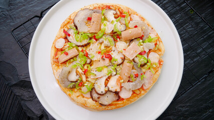 Delicious seafood pizza with shrimp mushrooms and cheese freshly baked on white plate