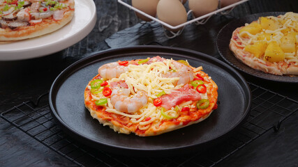 Grilled Italian Pizza with Cheese and Fresh Toppings on Dark Serving Plates